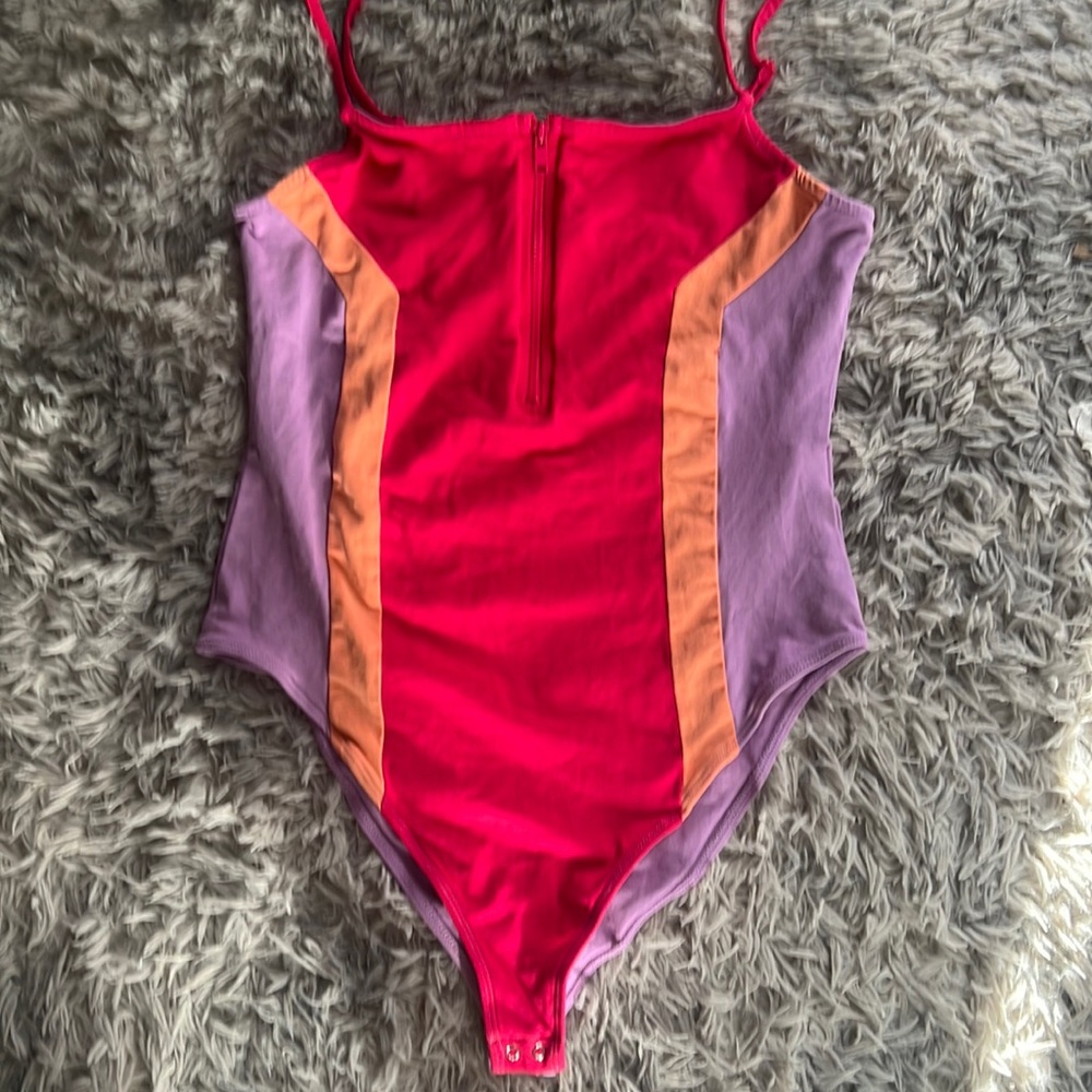 Super cute bodysuit. Never wore but tag is missing. Bright. Fun